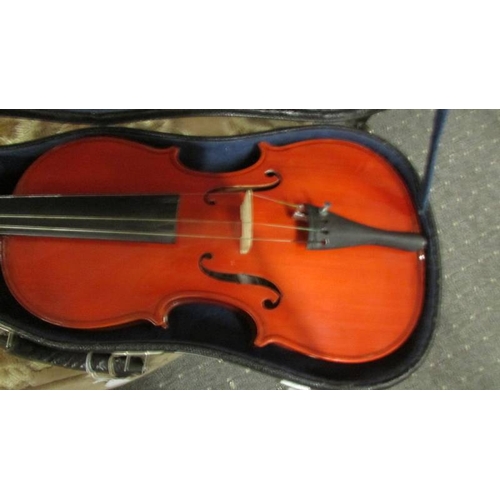 2569 - A cased violin.