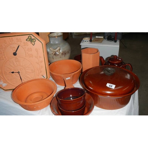 68 - A quantity of brown pottery including wall clock. (collect only)