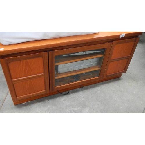 88 - A good teak TV stand and a video. (collect only)