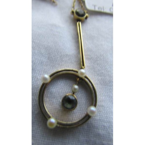 21 - A 9ct gold pendant set aquamarine and seed pearls, (chain a/f).