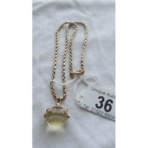 36 - A crystal fob with attached gold chain (tests as 9ct), chain 9 grams.