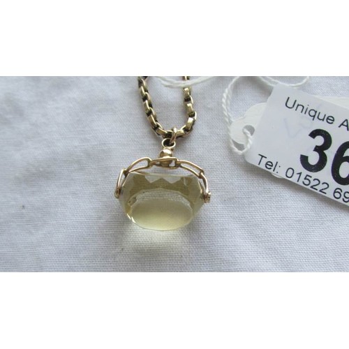 36 - A crystal fob with attached gold chain (tests as 9ct), chain 9 grams.