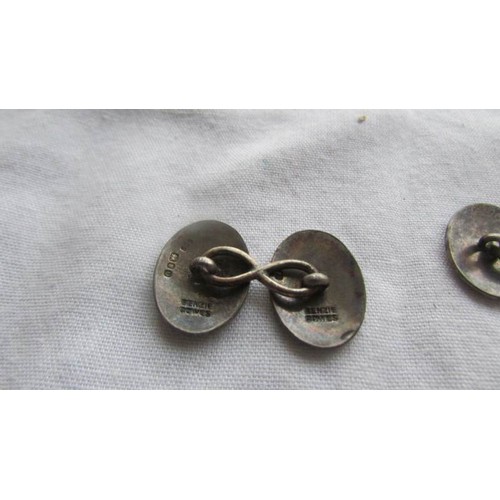 55 - A pair of silver 'pennant' cuff links.