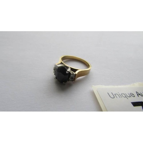 76 - An 18ct gold ring set sapphire and diamonds, size J.