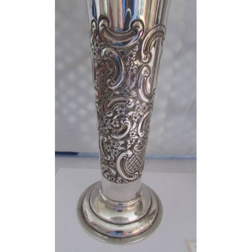 87 - A pair of silver embossed vases.