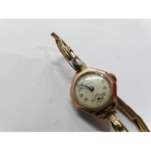 74 - An art deco 9ct gold cased Majex ladies wrist watch on rolled gold strap. in working order.