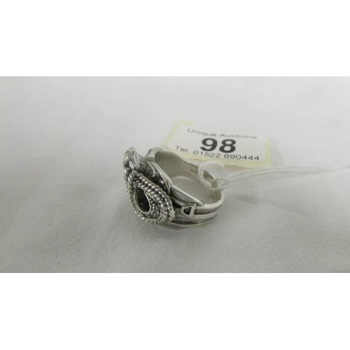 98 - A sterling silver saddle ring set zirconia stones, size V.