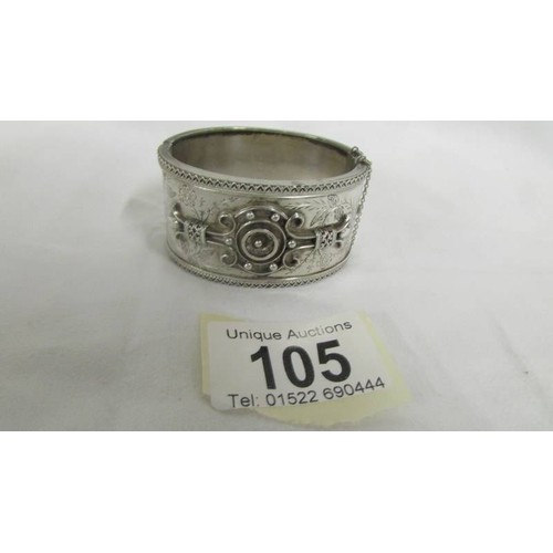 105 - A decorative silver bangle, 37.9 grams.