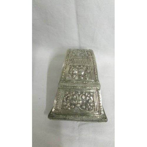 184 - An Eastern betel leaf holder in white metal.