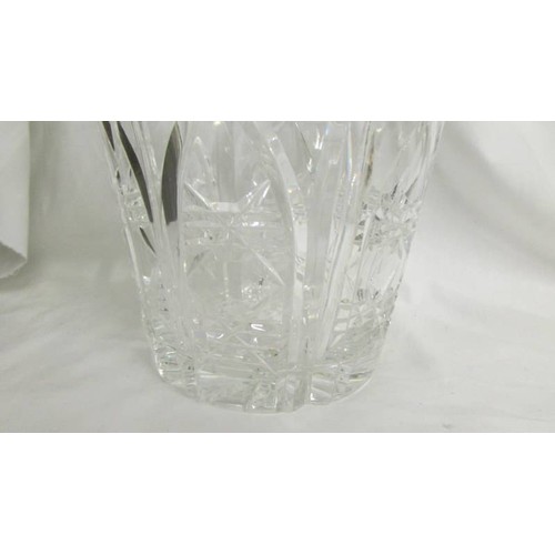 210 - A heavy cut glass vase, 23cm tall, 8.5 cm diameter at top.