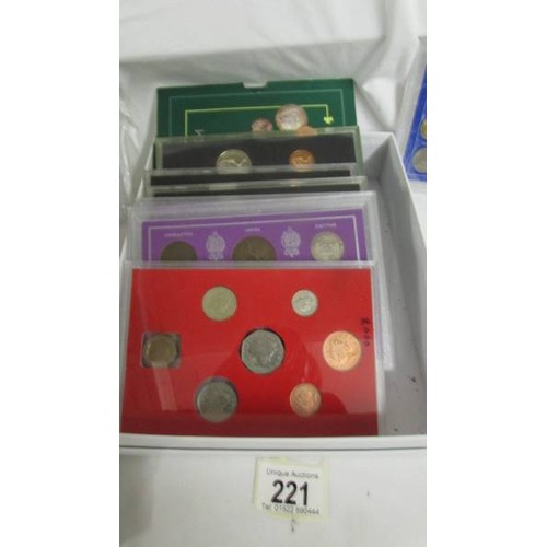 221 - A selection of UK coin sets including 1966 world cup, the coinage of George V, 1965 Churchill etc.,