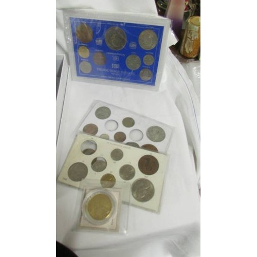 221 - A selection of UK coin sets including 1966 world cup, the coinage of George V, 1965 Churchill etc.,