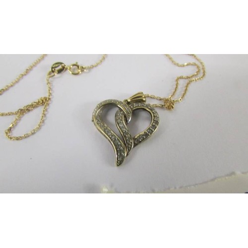 110 - A yellow gold and diamond heart on a 9ct gold chain.