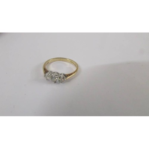 113 - A three stone yellow gold diamond cluster ring. size M half.