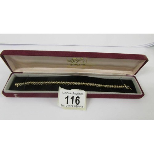 116 - A yellow gold and diamond tennis bracelet.