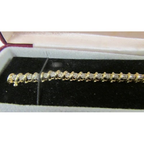 116 - A yellow gold and diamond tennis bracelet.