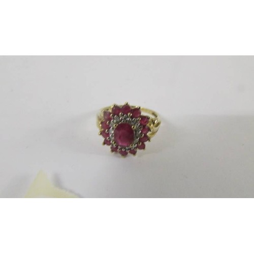 124 - A yellow gold ruby and diamond ring, size P.