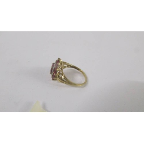 124 - A yellow gold ruby and diamond ring, size P.