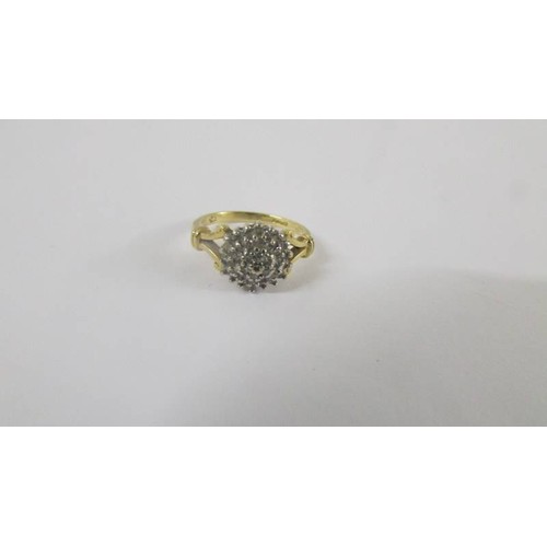 125 - A 18ct floral diamond ring with two diamonds on sides. size H.