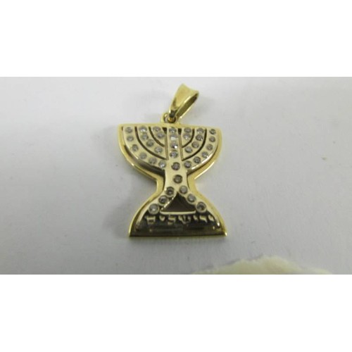 128 - An 18ct yellow gold diamond Menorah pendant.