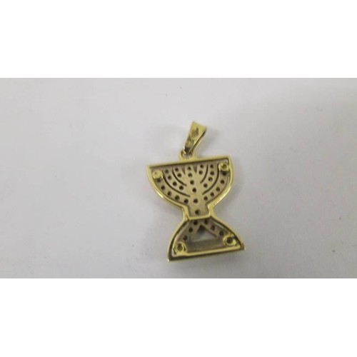 128 - An 18ct yellow gold diamond Menorah pendant.