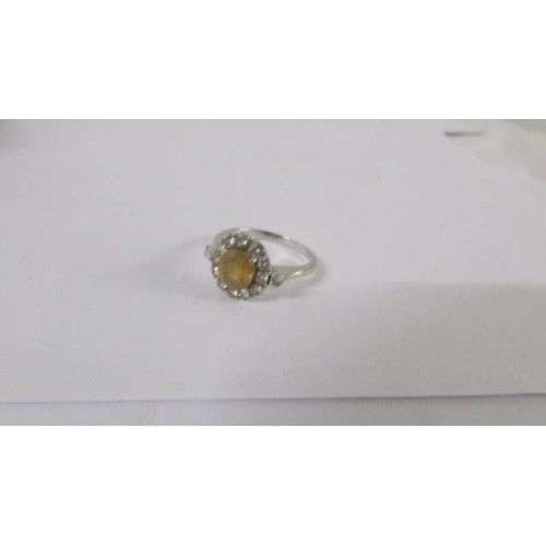 134 - A Yellow sapphire and diamond cluster ring, approximately 3 carats with 14 round brilliant cut diamo... 