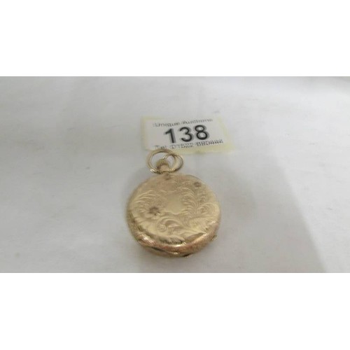 138 - A 14ct gold fob watch with chased gold work.