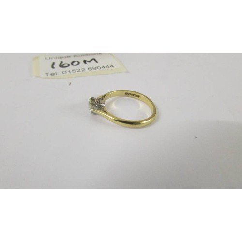 160M - A solitaire diamond ring mounted in 18ct gold and platinum. size L.