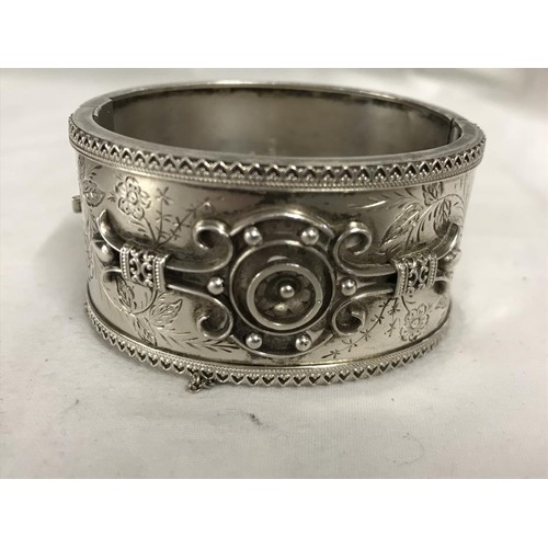 105 - A decorative silver bangle, 37.9 grams.