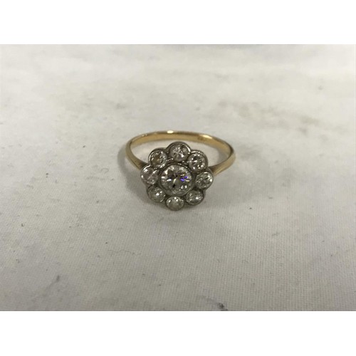 10 - An 18ct gold cluster ring with large central diamond surrounded by eight smaller diamonds, size 0 Ha... 