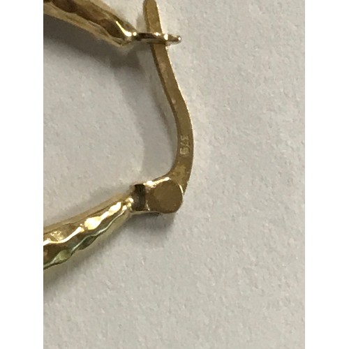 148 - A pair of gold hoop earrings in a textures 9ct gold, stamped.