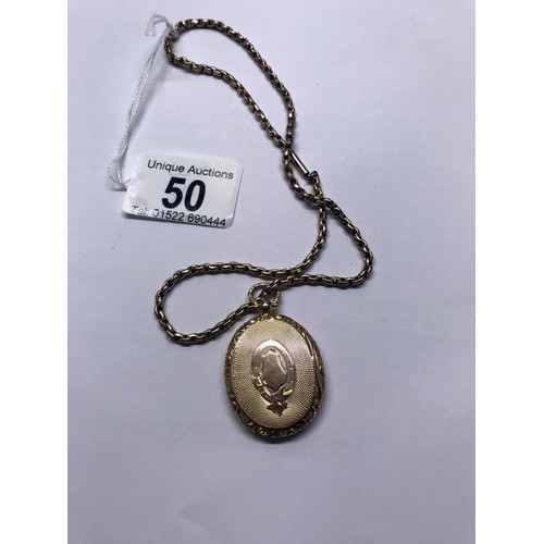 50 - A 15 ct gold locket. 10 grams, on a gold chain 8.8 grams.