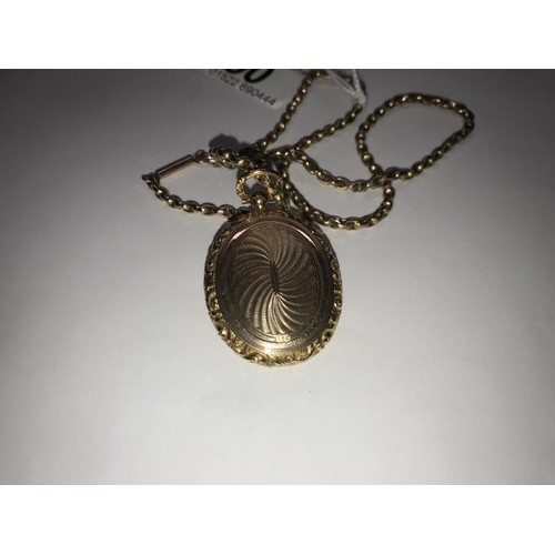 50 - A 15 ct gold locket. 10 grams, on a gold chain 8.8 grams.