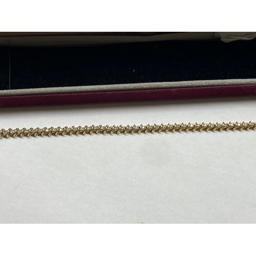 116 - A yellow gold and diamond tennis bracelet.