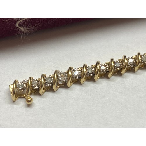 116 - A yellow gold and diamond tennis bracelet.