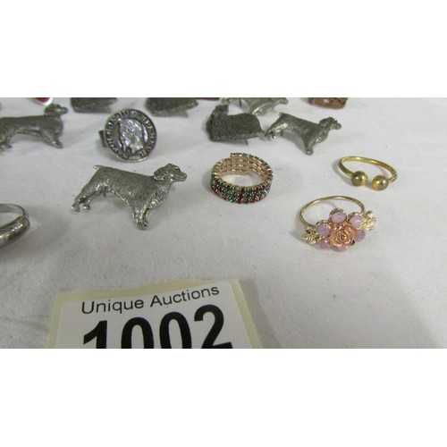 1002 - A mixed lot of rings, dog badges etc.,