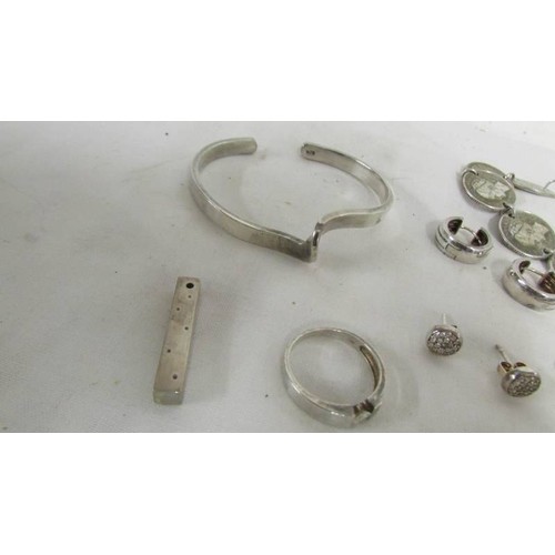 1019 - A silver charm bracelet, silver coin bracelet and other silver items.  (Approximately 65 g)