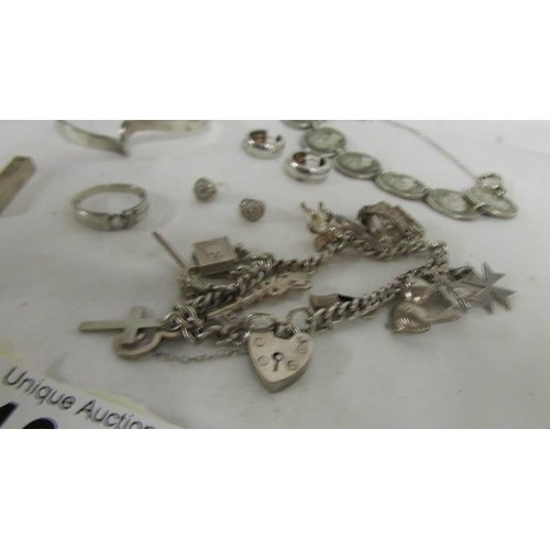 1019 - A silver charm bracelet, silver coin bracelet and other silver items.  (Approximately 65 g)