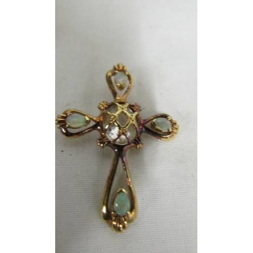 1026 - A 14k cross pendant set white stone and four opals, total weight 5.9 grams.