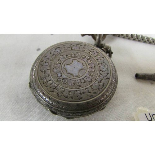 1031 - A Victorian ladies silver fob watch with ornate white metal chain.