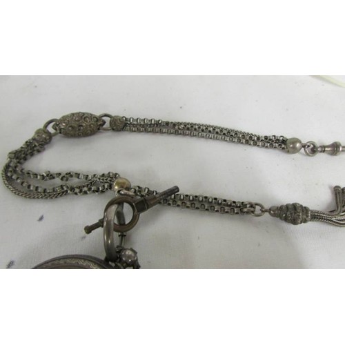 1031 - A Victorian ladies silver fob watch with ornate white metal chain.