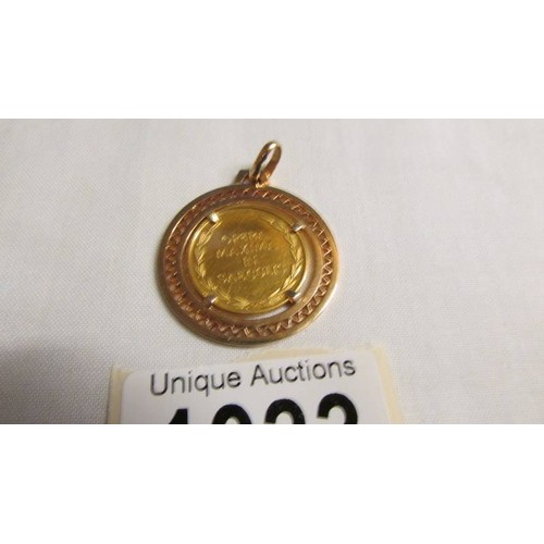 1033 - A gold coin in a 750 (18ct) gold pendant mount, total weight 11.4 grams.