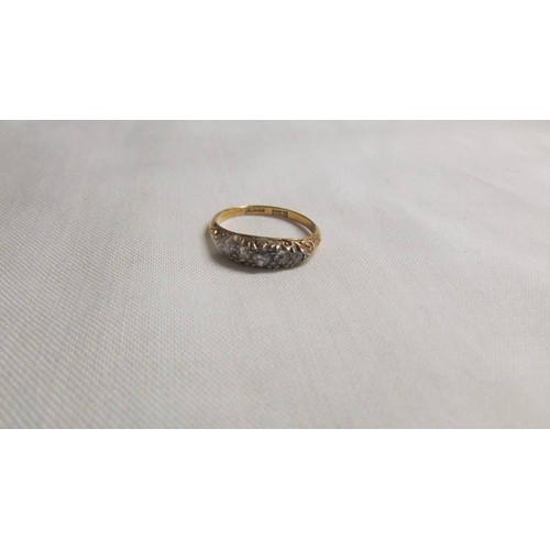 1034 - An 18ct gold and diamond ring, size J, 2.4 grams.