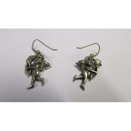 1045 - A pair of silver Cupid earrings and another pair of silver earrings.