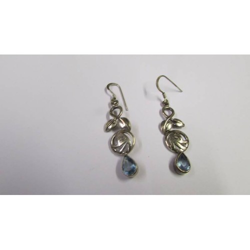 1045 - A pair of silver Cupid earrings and another pair of silver earrings.