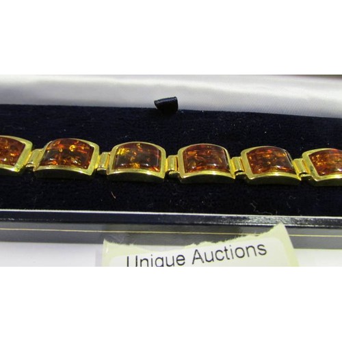 1053 - A gold plate on silver amber bracelet marked 925.