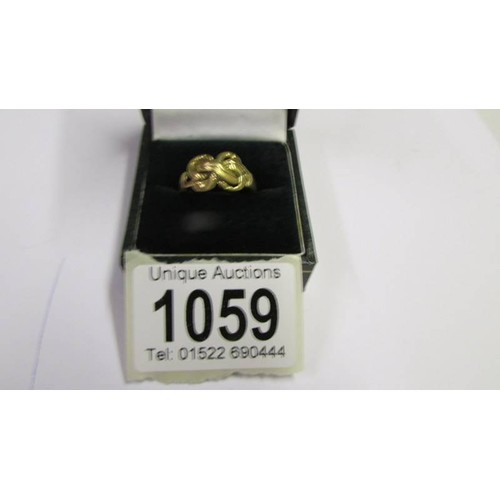 1059 - An 18ct gold rope twist ring, size P half, 4.4 grams.