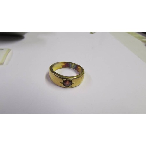 1061 - A gold ring set red stone, (Has been made smaller so hall mark removed) size R.  8.9 grams.