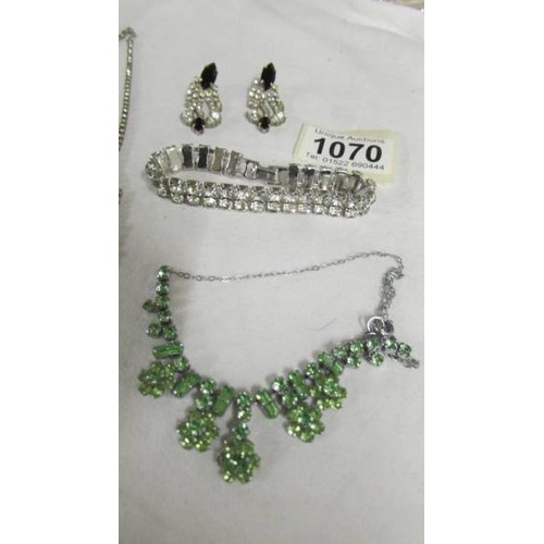 1070 - Two vintage necklaces, one with matching earrings and a bracelet in paste.