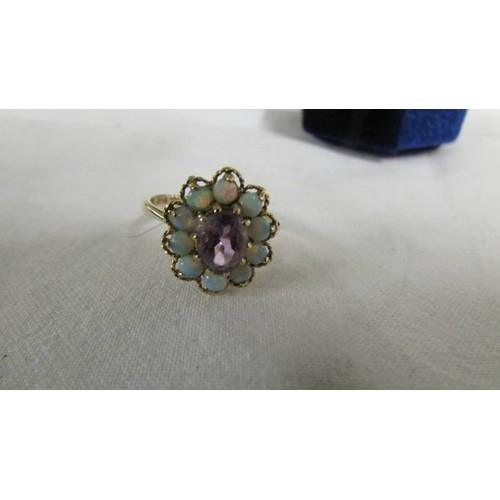 1071 - An opal and amethyst set cluster ring in 9ct gold, size K.